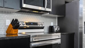 A modern kitchen with stainless steel appliances, a microwave, and a toaster.