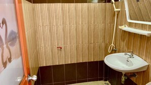 A bathroom with a wooden panel wall, a white sink, and a shower. - Baan Kenpoo Resort (Phetchaburi)