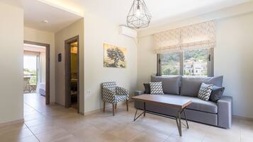 Deluxe Apartment, 1 King Bed with Sofa bed, Balcony, Pool View | Living area | 42-inch LCD TV with digital channels