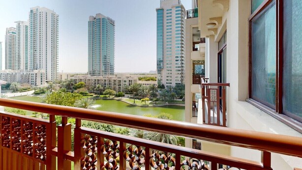 A balcony with a view of high-rise buildings and a lake. - 605 Turia BlockA, The Greens (The Greens)