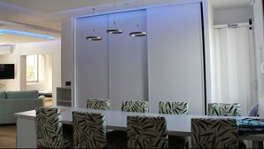 A modern dining area with a white table, patterned chairs, and pendant lights. - Spacious cocoon in Six-Fours-les-Plages (Six-Fours-les-Plages)
