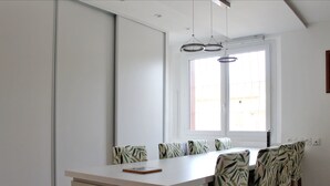A modern kitchen with a white countertop, a built-in oven, and a window with blinds. - Spacious cocoon in Six-Fours-les-Plages (Six-Fours-les-Plages)