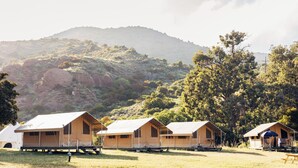 A row of tents with a view of a mountainous landscape. - White s Landing Catalina Camp (Avalon)