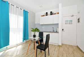 Fridge, stovetop, electric kettle, cookware/dishes/utensils