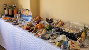 A buffet table with various food items and beverages. - Scario Club (San Giovanni a Piro)