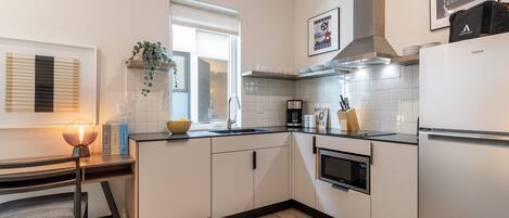 Fridge, microwave, stovetop, coffee/tea maker
