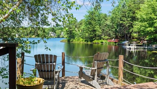 A wooden dock with Adirondack chairs and a potted plant. - Simply Shores by AvantStay | Private Beach + Dock | Lake Overlook (Long Pond)
