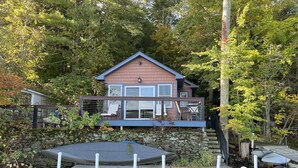 A house with a dock and a small boat. - Waterfront Cottage 10 Min From Great Barrington (New Marlborough)