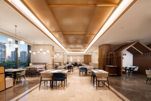 A spacious conference room with long tables, chairs, and a high ceiling with recessed lighting. - Hilton Garden Inn Beijing West Railway Station (Beijing)