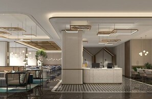 Un moderno vestíbulo de hotel con mostrador de recepción, zona de estar y suelo estampado.