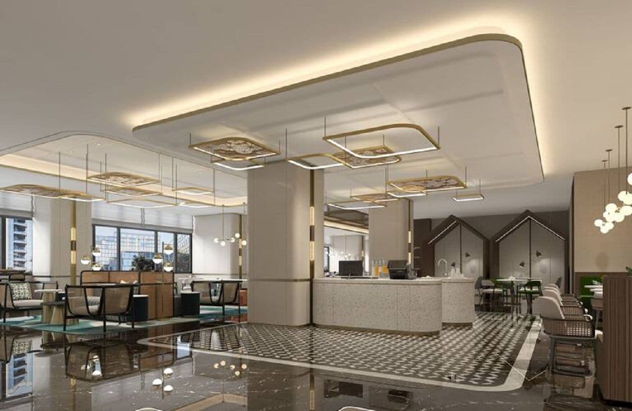Een moderne hotel lobby met een centraal receptiebalie, zithoeken en een vloer met een patroon.