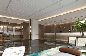 En modern hotellobby med en receptionsdisk, en sittgrupp och en pool.