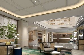 Eine moderne Lobby mit gewölbter Decke, Sitzbereichen und einer zentralen Treppe.
