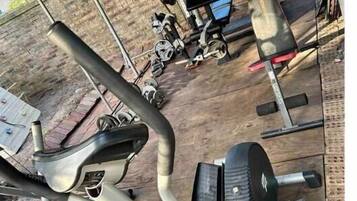 A gym with exercise equipment including treadmills, weight machines, and free weights.