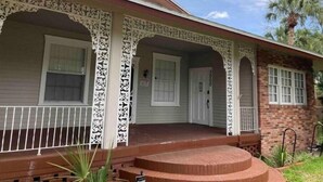 A house with a covered porch, a brick section, and a garage door. - Peaceful Private Gated Patio Walk to Mall Publix

 (Altamonte Springs)