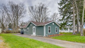 A single-story house with a front porch, a driveway, and a well-maintained lawn. - Angola Getaway: Walk to Lake Erie Beach Park! (Angola)