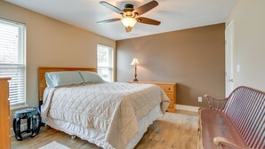 A bedroom with a bed, nightstand, lamp, and a wooden bench. - Angola Getaway: Walk to Lake Erie Beach Park! (Angola)