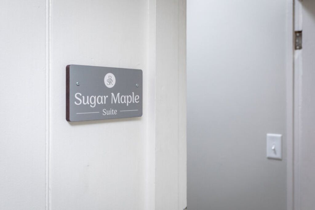 A sign for the Sugar Maple Suite in a hotel.
