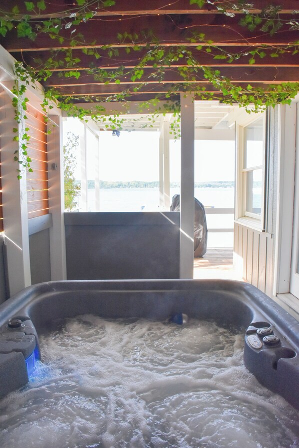 A hot tub with a wooden ceiling and a view of the outdoors. - Ultimate Lakefront Getaway: Hot Tub/Boat Dock/& Game Room! (Beulah)