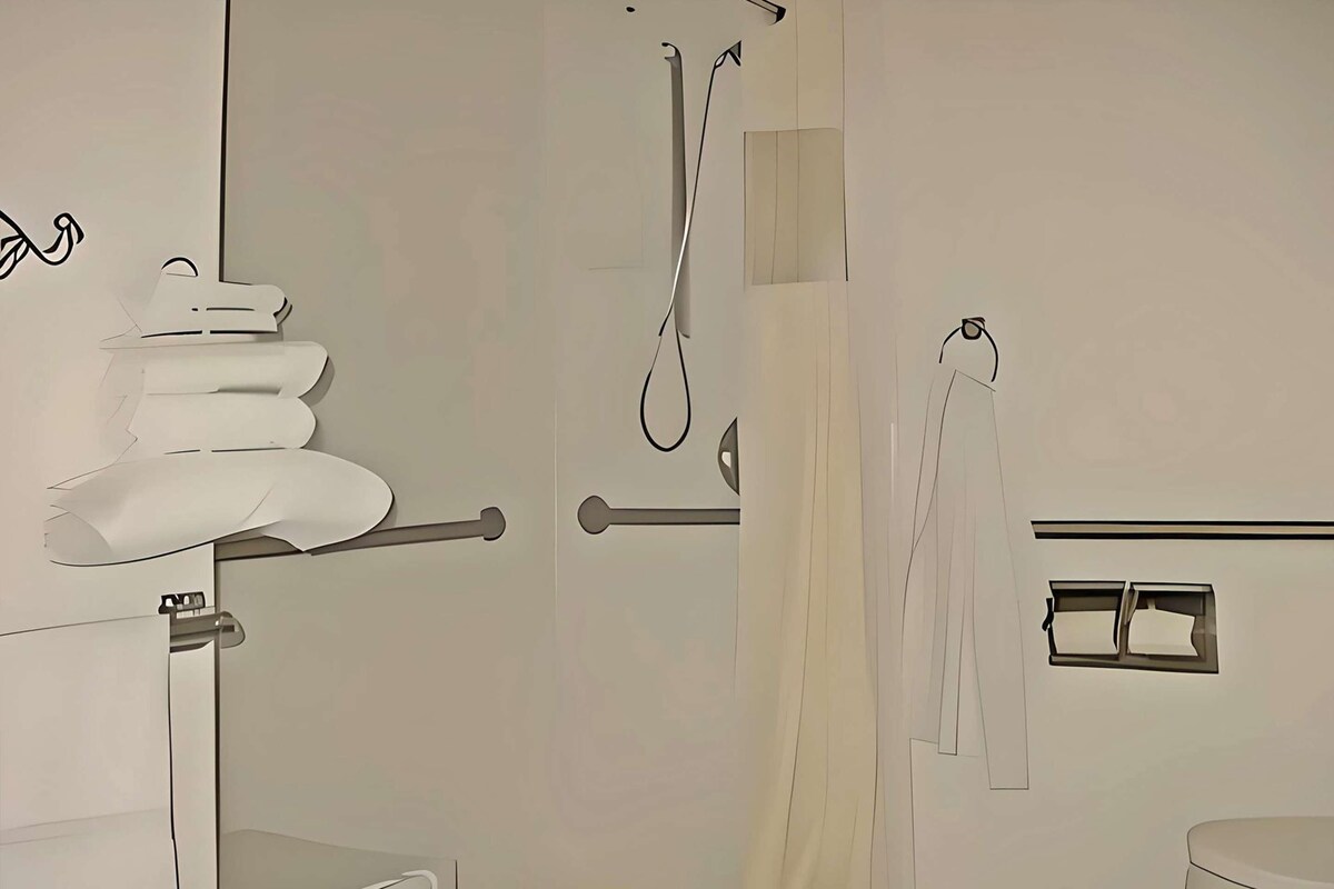 A bathroom with a toilet, a shower, and a sink.