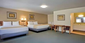 A hotel room with two beds, a desk, and a chair. - Travelodge by Wyndham Red Bluff South of Redding (Red Bluff)