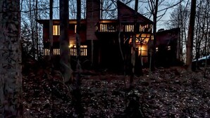 A cabin with a wooden exterior, surrounded by trees and a leaf-covered ground. - Cozy Home:  Close to UT, Smoky Mountains and outdoor fun  (Knoxville)