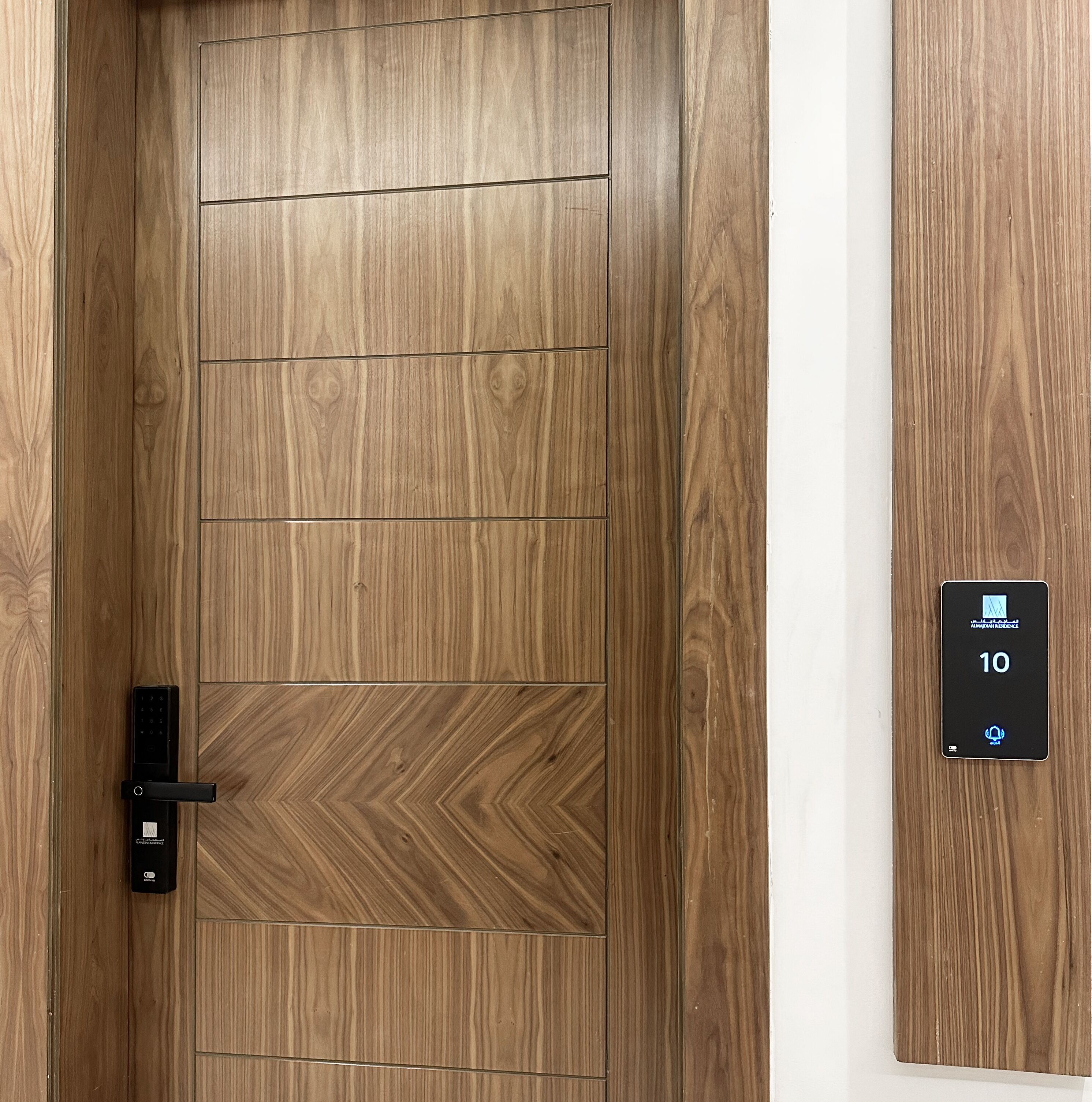 A wooden door with a keypad lock and a digital display showing the number 10.