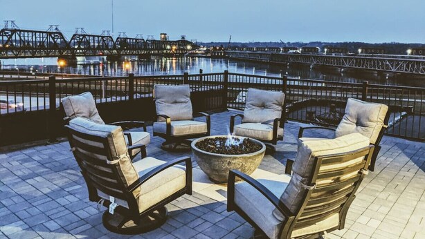 Outdoor seating with a fire pit, overlooking a waterfront with a bridge. - The Nelson Lofts - Unit 7 (2 BR) (Davenport)