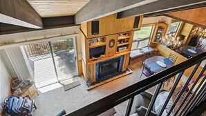 A modern interior with a fireplace, wooden furniture, and a dining area. - St Francis Townhome with Amenities, near the lake (Tahoe City)