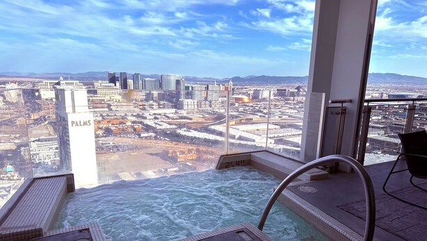 A rooftop jacuzzi with a city view, a sign reading "PALMS", and a glass balustrade. - The VIBE PALMS PLACE PENTHOUSE  (Las Vegas)