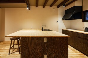 Enjoy cooking in this kitchen with a large island, sink, and black range hood.