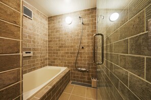 Bathroom features a spacious bathtub and walk-in shower.