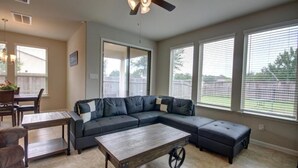 A living room with a sectional sofa, a coffee table, and a ceiling fan. - Roseberg/Suglarland  3-BR - Extended Stay 30 days  (Rosenberg)