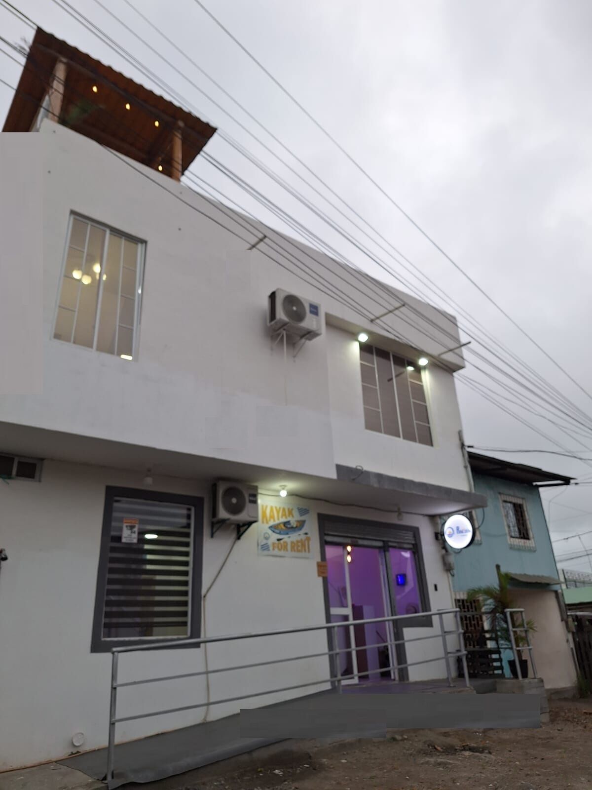 A modern building with a sign for kayak rental.