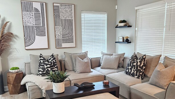A modern living room with a sectional sofa, a coffee table, and decorative pillows. - NEWLY RENOVATED 1100 Sq ft! Bungalow Retreat 5 minutes from Theme Park and Beach (Atlantic City)