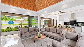 Exclusive Villa | Living area | 65-inch TV with cable channels