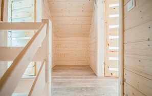 A narrow wooden hallway with a sloped ceiling and a wooden floor. - Beautiful home in Sarbinowo with WiFi (Sarbinowo)