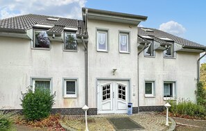 Stunning two-story residence with a central entrance and beautifully maintained garden.