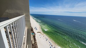 A balcony with a view of a beach and ocean. - Direct Beachfront Condo Near Pier Park! 2BD+Bunk 3BA, 2 Free Parking! (Panama City Beach)