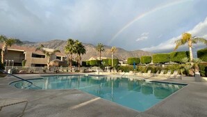 A swimming pool with lounge chairs, palm trees, and mountains in the background. - New! Downtown Zen Oasis: Best Value, 2 Patios (Palm Springs)
