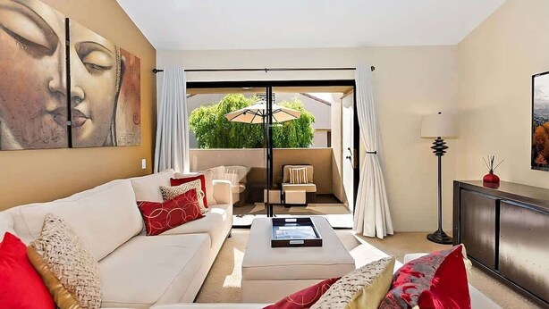 A modern living room with a sofa, coffee table, and artwork on the wall. - New! Downtown Zen Oasis: Best Value, 2 Patios (Palm Springs)