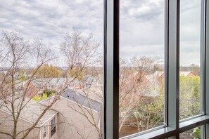 Guests can enjoy a serene view of the surrounding residential area and lush trees from the comfort of their room.