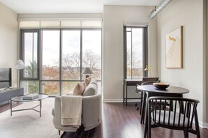Relax in a spacious living area with a sofa, armchairs, and a flat-screen TV.