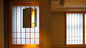 A room with a traditional Japanese shoji screen door and a hanging light fixture. - Kyoto Gion Hotel (Kyoto)
