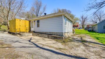 A single-story mobile home with a small porch and a fenced yard.