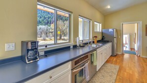 A kitchen with a built-in coffee maker, a refrigerator, and a sink. - Close to Hot Springs: Chalk Creek Meadows Home! (Nathrop)