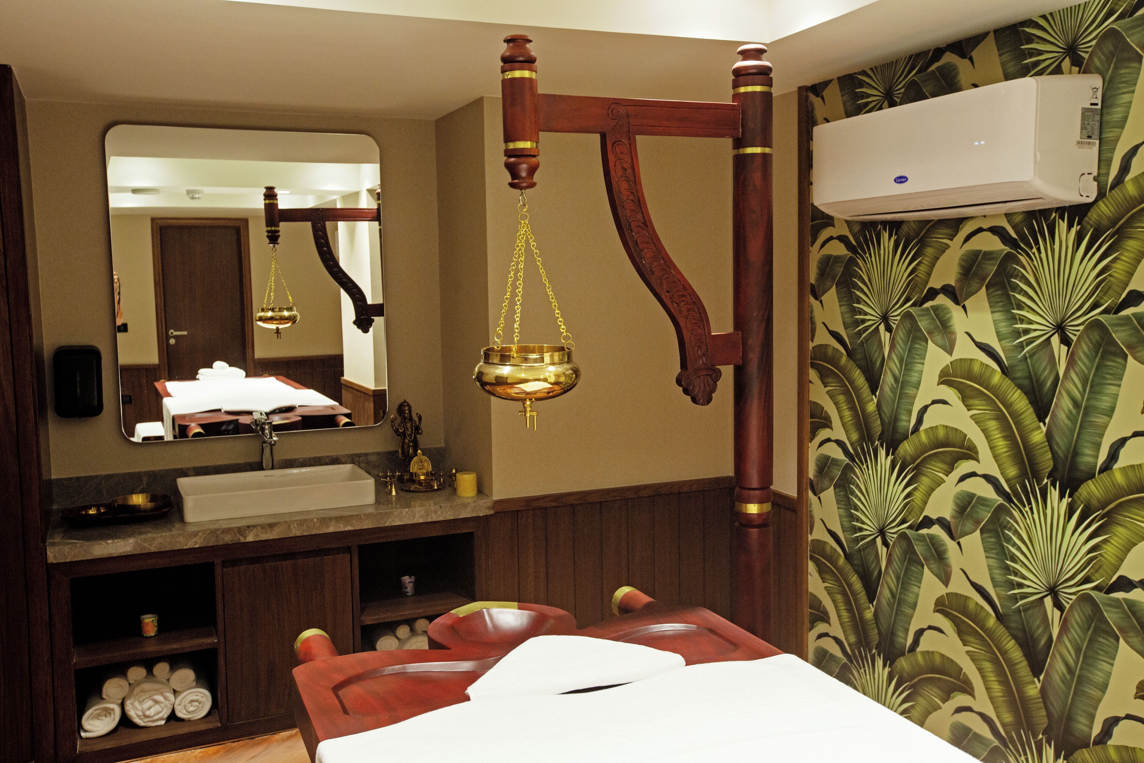 A bathroom with a wooden vanity, a mirror, a sink, and a shower area.
