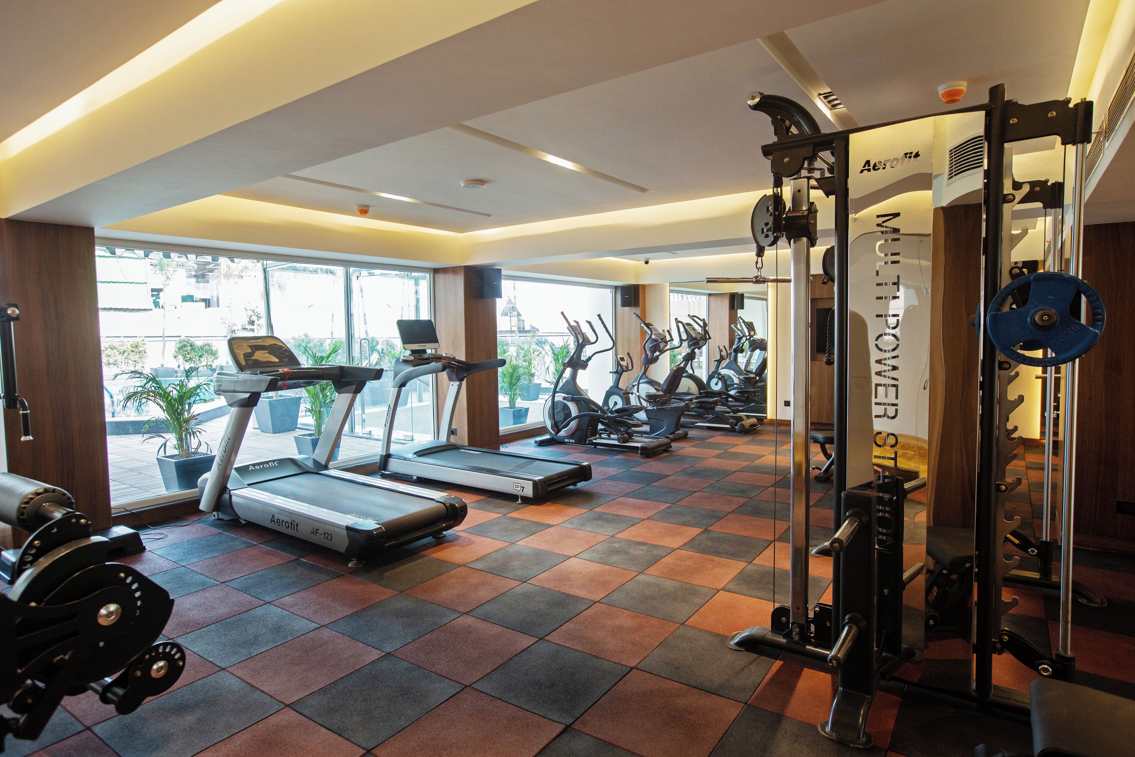 A gym with treadmills, stationary bikes, and weight machines.