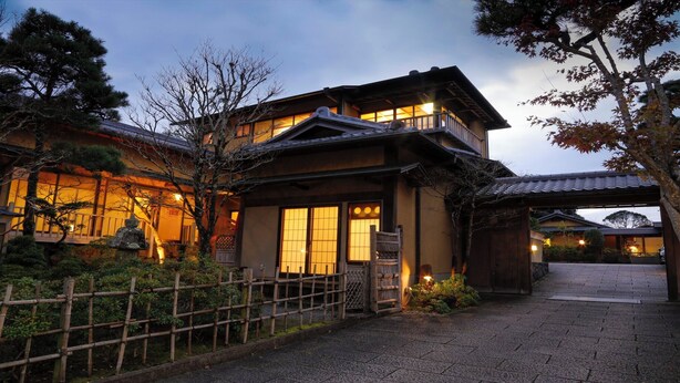 A traditional Japanese house with a wooden facade, large windows, and a covered entrance. - Koto no Yado Musashino (Nara)