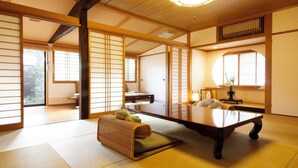 A traditional Japanese room with tatami flooring, a low table, and sliding doors. - Koto no Yado Musashino (Nara)